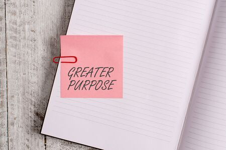 Writing note showing Greater Purpose. Business concept for Extend in average conforming the moral order of the universe Notebook stationary placed above classic wooden backdropの写真素材