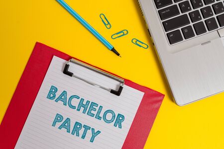 Word writing text Bachelor Party. Business photo showcasing Party given for a analysis who is about to get married Stag night Open laptop clipboard blank paper sheet marker clips colored backgroundの写真素材