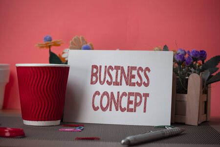 Writing note showing Business Concept. Business concept for new product approach to marketing or delivering it Flowers and writing equipments sheet above textured backdropの写真素材
