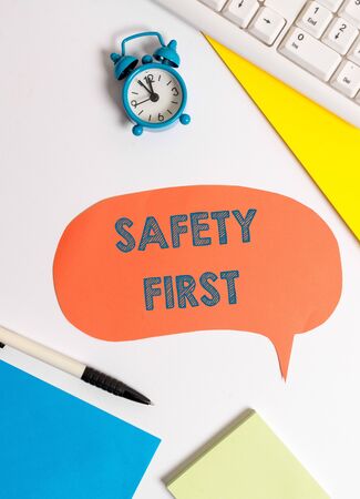 Writing note showing Safety First. Business concept for used to say that the most important thing is to be safeの写真素材