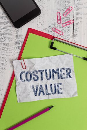 Handwriting text Costumer Value. Conceptual photo Amount of benefits which clients get from purchasing products Clipboard paper sheet pencil smartphone note clips wooden retro backgroundの写真素材