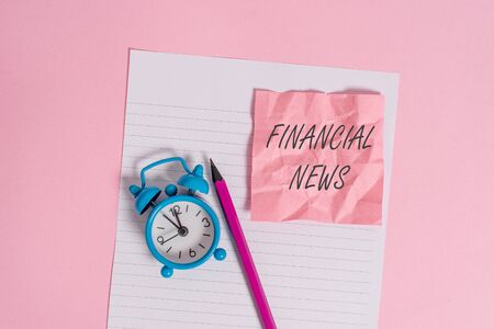 Writing note showing Financial News. Business concept for Investment banking Fund analysisagement Regulation and trading Striped paper sheet note pencil vintage alarm clock colored backgroundの写真素材