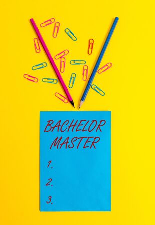 Word writing text Bachelor Master. Business photo showcasing An advanced degree completed after bachelor s is degree Blank paper sheet message reminder pencils clips colored backgroundの写真素材