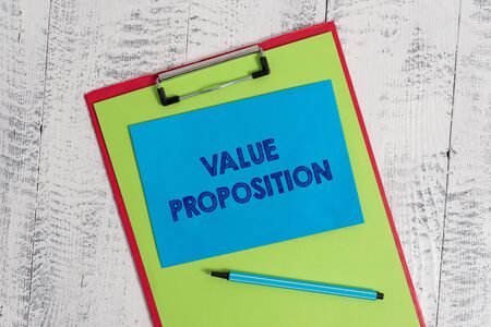 Text sign showing Value Proposition. Business photo showcasing feature intended to make a company or product attractive Colored clipboard blank paper sheet marker sticky note wooden backgroundの写真素材