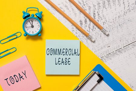 Word writing text Commercial Lease. Business photo showcasing refers to buildings or land intended to generate a profit Notepads clips paper sheet clipboard markers alarm clock wooden backgroundの写真素材
