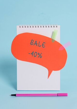 Conceptual hand writing showing Sale 40 Percent. Concept meaning A promo price of an item at 40 percent markdown Spiral notepad speech bubble arrow pen lying pastel backgroundの写真素材