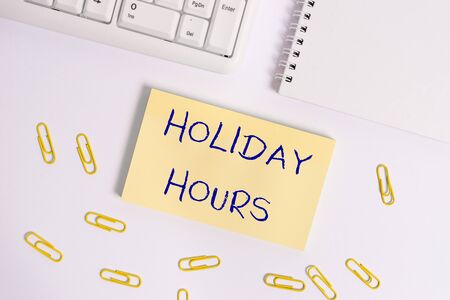 Conceptual hand writing showing Holiday Hours. Concept meaning employee receives twice their normal pay for all hoursの写真素材