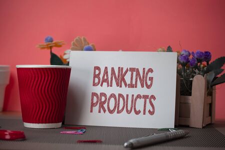 Writing note showing Banking Products. Business concept for safe and convenient way or service to accumulate savings Flowers and writing equipments sheet above textured backdropの写真素材