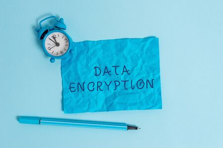 Writing note showing Data Encryption. Business concept for Symmetrickey algorithm for the encrypting electronic data Metal vintage alarm clock crushed sheet marker sky colored backgroundの写真素材