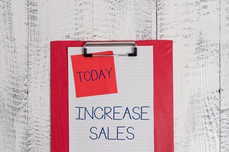 Conceptual hand writing showing Increase Sales. Concept meaning Boosting the product sold to customers Trade Growth Colored clipboard blank paper sheet sticky note wooden backgroundの写真素材