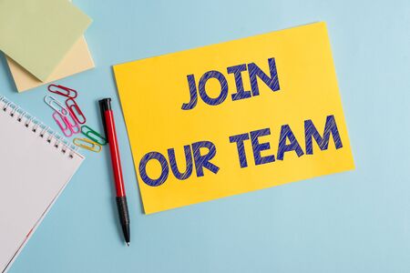 Writing note showing Join Our Team. Business concept for inviting someone to join in your local group or company Plain cardboard and writing equipment placed on pastel colour backdropの写真素材