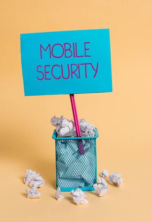 Word writing text Mobile Security. Business photo showcasing Protection of mobile phone from threats and vulnerabilities crumpled paper trash and stationary with note paper placed in the trash canの写真素材