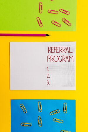 Text sign showing Referral Program. Business photo text sending own patient to another physician for treatment Blank squared notebook pencil marker paper sheets plain colored backgroundの写真素材
