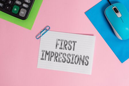 Conceptual hand writing showing First Impressions. Concept meaning What a demonstrating thinks of you when they first meet you Wire electronic mouse calculator paper colored backgroundの写真素材