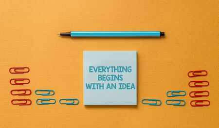 Handwriting text Everything Begins With An Idea. Conceptual photo steps you take to turn an idea into a reality Colored blank sticky note clips binders gathered pen trendy cool backgroundの写真素材