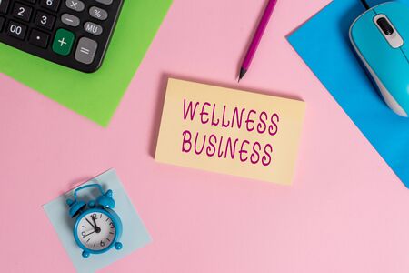 Handwriting text writing Wellness Business. Conceptual photo Professional venture focusing the health of mind and body Mouse calculator sheets marker notepad alarm clock colored backgroundの写真素材