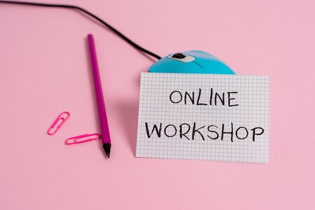 Word writing text Online Workshop. Business photo showcasing shows of goods and commodities over the electronic websites Wire vintage mouse clips marker squared paper sheet colored backgroundの写真素材