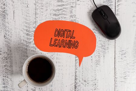 Conceptual hand writing showing Digital Learning. Concept meaning accompanied by technology or by instructional practice Wooden vintage table background coffee cup speech bubbleの写真素材