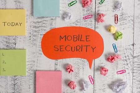 Word writing text Mobile Security. Business photo showcasing Protection of mobile phone from threats and vulnerabilities Blank speech bubble paper balls clips sticky notes old wooden backgroundの写真素材