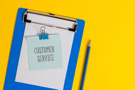 Handwriting text writing Customer Service. Conceptual photo process of ensuring client satisfaction with product Clipboard holding blank paper sheet note binder pencil colored backgroundの写真素材