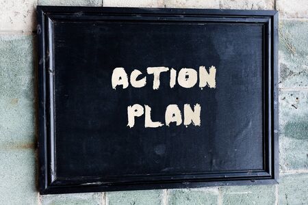 Writing note showing Action Plan. Business concept for proposed strategy or course of actions for certain timeの写真素材