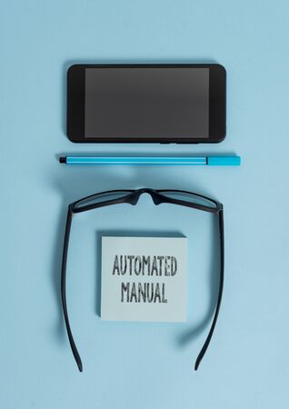 Conceptual hand writing showing Automated Manual. Concept meaning as trigger shift and it can switch between moods easily Dark eyeglasses colored sticky note smartphone pastel backgroundの写真素材
