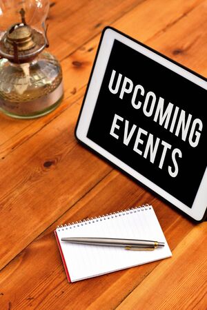 Handwriting text writing Upcoming Events. Conceptual photo the approaching planned public or social occasions Writing equipments placed next to gadget plus a classic vintage lanternの写真素材