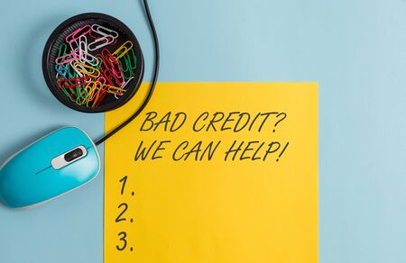 Conceptual hand writing showing Bad Creditquestion We Can Help. Concept meaning offerr help to gain positive payment history Notebook and stationary with gadgets above pastel backdropの写真素材