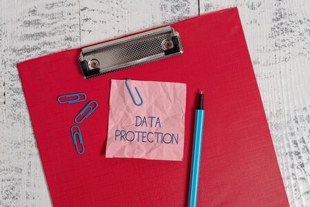 Writing note showing Data Protection. Business concept for Protect IP addresses and demonstratingal data from harmful software Colored clipboard crushed sticky note clip marker old wooden backgroundの写真素材