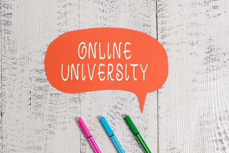 Handwriting text writing Online University. Conceptual photo Distance Learning Courses are taken over the internet Ballpoints blank colored speech bubble wooden rustic vintage backgroundの写真素材