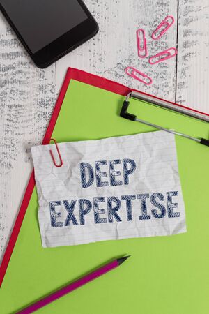 Handwriting text Deep Expertise. Conceptual photo Great skill or broad knowledge in a particular field or hobby Clipboard paper sheet pencil smartphone note clips wooden retro backgroundの写真素材