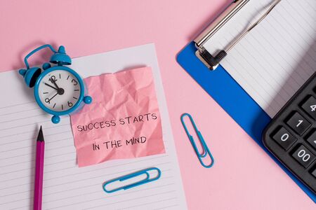 Conceptual hand writing showing Success Starts In The Mind. Concept meaning set your mind to positivity it can go a long way Paper sheet clipboard pencil calculator clock colored backgroundの写真素材