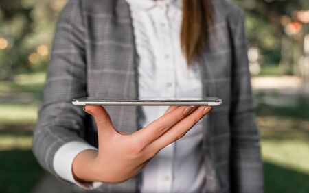 Outdoor scene with business woman holds lap top with touch screen.の写真素材