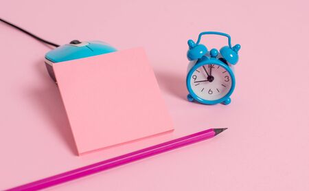 Vintage alarm clock wire mouse empty notepad markers colored backgroundの写真素材