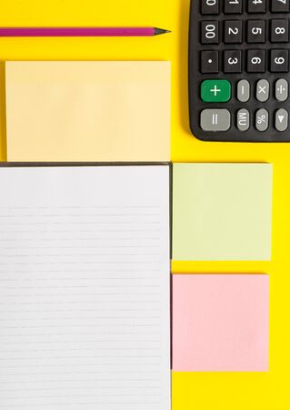 Colored empty papers with copy space on the yellow background table.の写真素材