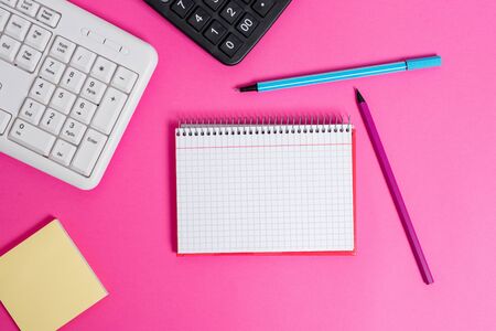 Writing equipments and computer stuffs placed above classic wooden tableの写真素材