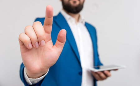 Businessman with pointing finger in front of him.