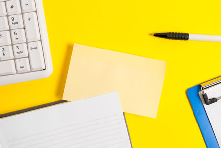 Empty orange paper with copy space on the yellow table. Blank paper for text messages.