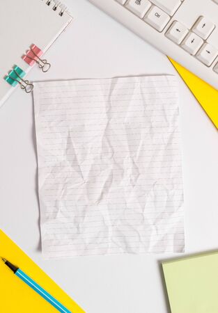 Colored paper different sizes binder clip sheets white desk empty spaceの写真素材