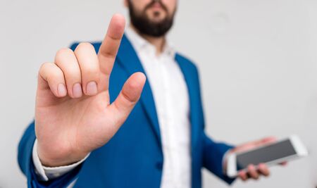 Businessman pointing with pen in empty copy space.の写真素材