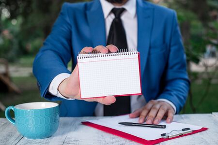 Man holds empty paper with copy space in front of him.の写真素材