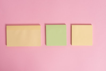 Close up front view three multicolor blank notepads colored background