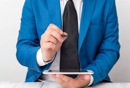 Businessman pointing with pen in empty copy space.の写真素材
