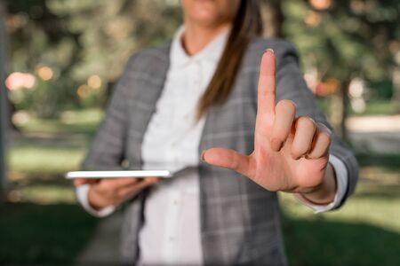 Outdoor scene with business woman holds lap top with touch screen.の写真素材