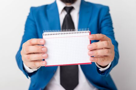 Man holds empty paper with copy space in front of him. White space for advertising message.の写真素材