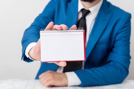 Man holds empty paper with copy space in front of him. White space for advertising message.の写真素材