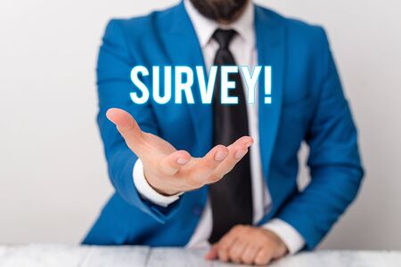 Text sign showing Survey. Business photo text research method used for collecting data from a predefined group Man holds empty paper with copy space in front of him Copy Spaceの写真素材