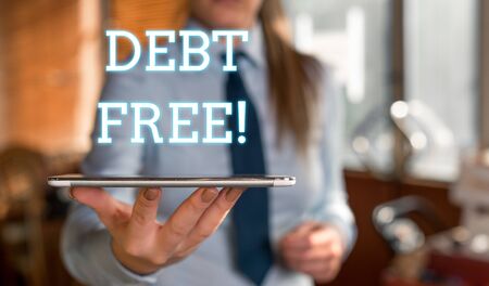 Word writing text Debt Free. Business photo showcasing does not owning any money or things to any individual or companies Blurred woman in the background pointing with finger in empty spaceの写真素材