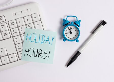Text sign showing Holiday Hours. Business photo text Overtime work on for employees under flexible work schedules White pc keyboard with empty note paper above white backgroundの写真素材