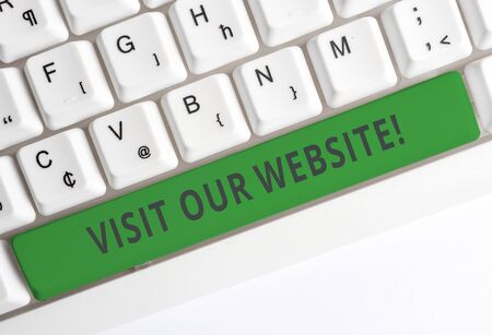 Text sign showing Visit Our Website. Business photo showcasing visitor who arrives at web site and proceeds to browse White pc keyboard with empty note paper above white background key copy spaceの写真素材